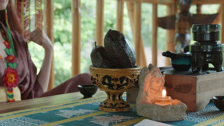 Tea ceremoтy on the wooden table before the start of the gong ceremony in a gazebo on the Bali island with cacao eans