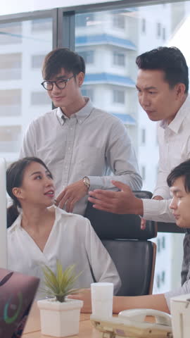 Vertical Screen : Collaborative of multicultural businesspeople using computer presentation and communication meeting brainstorming ideas about project colleagues work plan success strategy in office.