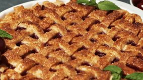 Sliding shot over delicious homemade cherry pie with Flaky Crust as a textured background. American traditional pastry. Flat lay. Fresh summer berry tart dessert sprinkled with sugar - Powered by Shutterstock - Get 15% off with code: PIKWIZARD15