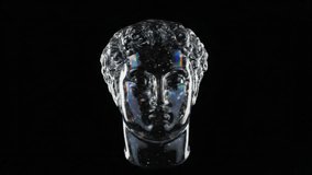 The 3D glass head of the ancient hero, located on a black background, performs a full 360-degree rotation cycle around its axis and glitters with an iridescent spectrum of all the colors of the rainbo - Powered by Shutterstock - Get 15% off with code: PIKWIZARD15