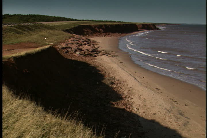PRINCE EDWARD ISLAND, CANADA - CIRCA OCTOBER 2000: Waves gently wash up onto beach and coastline.