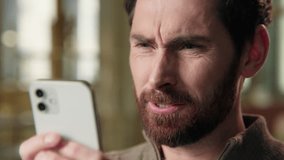 Close up angry middle-aged business man texting message mobile phone in hands typing smartphone annoyed furious man businessman stressed male guy in office displeased chatting negative sms cellphone - Powered by Shutterstock - Get 15% off with code: PIKWIZARD15