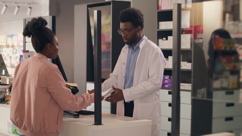 African American man pharmacist assist customer in pharmacy medicine prescription customer woman buying pills healthy medication vitamins drugs shopping pharmaceutics order help sickness treatment