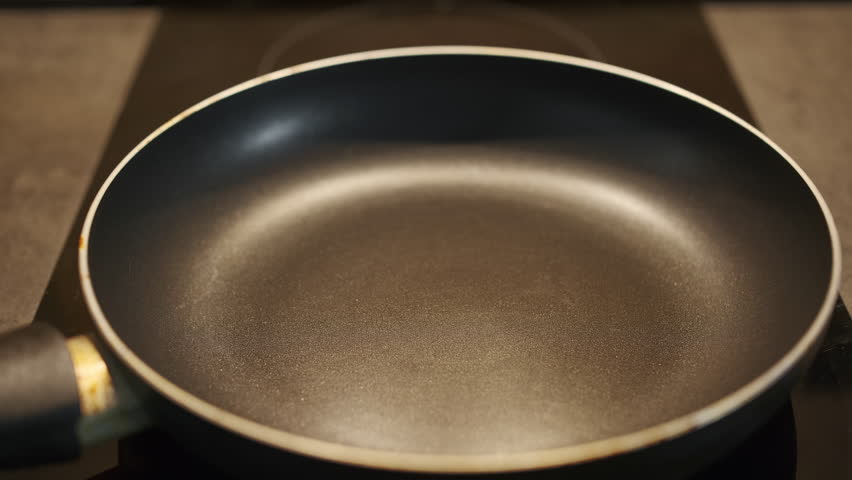 Chef pours olive oil on a hot frying pan and adds tomatoes for frying, traditional Turkish omelet menemen cooking video