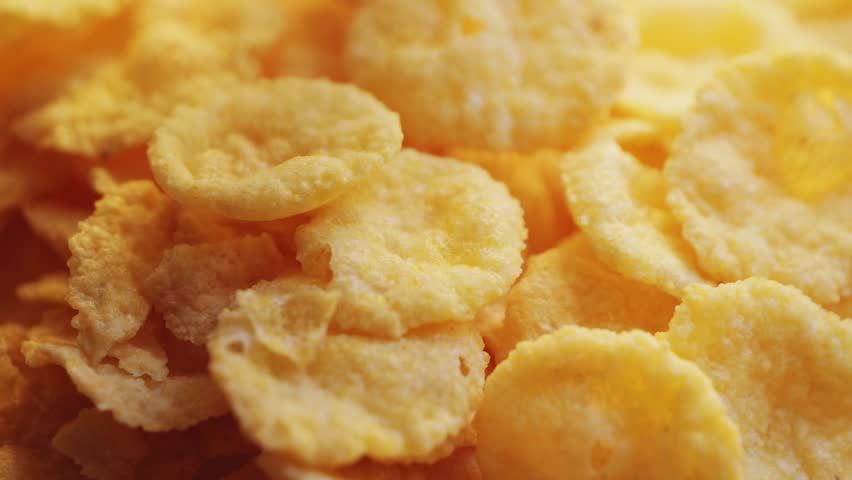Crispy yellow cornflakes close up footage. Breakfast concept. High quality 4k footage