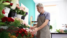 Skilled florist creating vibrant flower arrangement at boutique shop, displaying artistic expertise in professional floral design and decorative composition - Powered by Shutterstock - Get 15% off with code: PIKWIZARD15