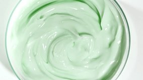 Green Smooth Skin Cream Texture. Beauty Facial Cosmetics. Women's Cosmetics Skincare. Macro Shot of Natural Organic Cosmetics, Medicine. Production Close-up. Slow Motion  - Powered by Shutterstock - Get 15% off with code: PIKWIZARD15