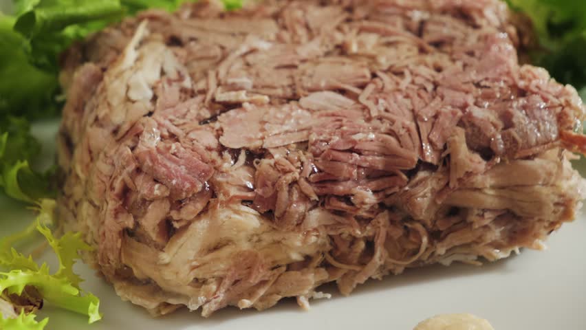 Prepared homemade beef aspic on plate, topping with parsley and dill. High quality 4k footage