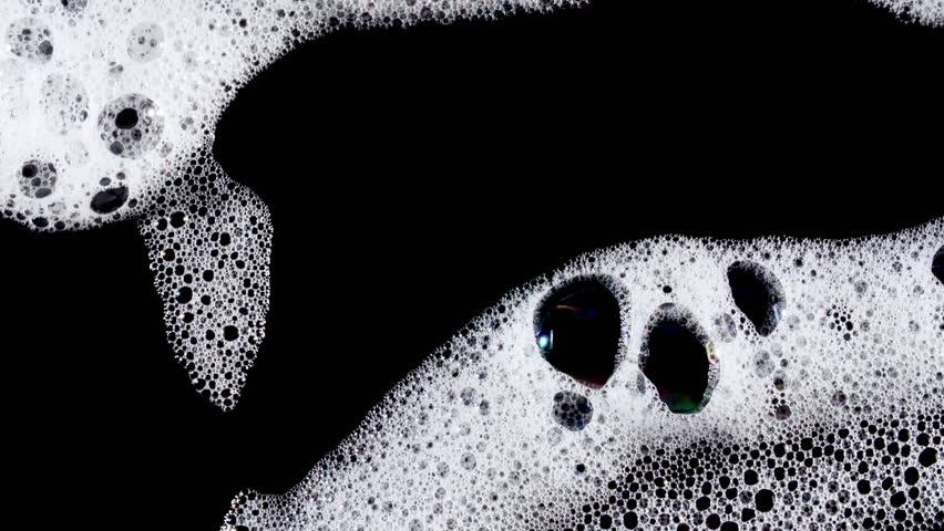 Texture of white soap foam with bubbles abstract background. Soap sud macro structure. Bathtup Soap Foam. Natural White Shampoo Bubbles Motion.
