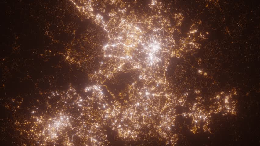 Raleigh (North Carolina, USA) aerial view at night. Top view on modern city with street lights. Camera is zooming out, rotating clockwise. Vertical video. The north is on the left side