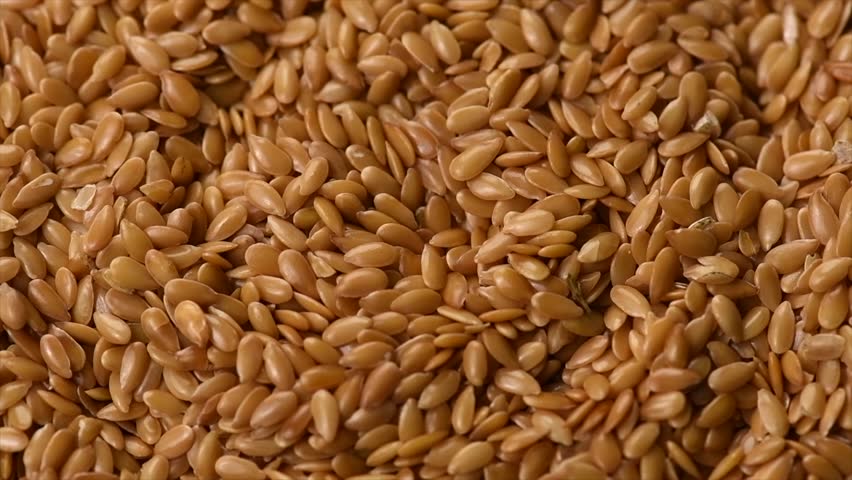 Linseed. Flaxseed Background. Flax seeds closeup. Linen seed. Healthy vegan food backdrop rotating, diet. Top view, flat lay