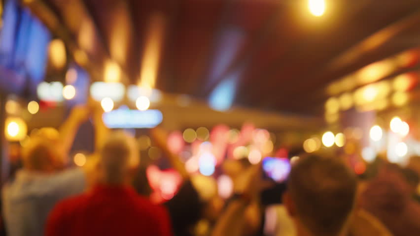 A Blurry Crowd Captured at a Live Music Event Filled with Colorful Lights and Exciting Vibes and Sounds