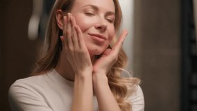Pretty Caucasian woman look mirror massaging neck face cream beauty routine at home beautiful girl female touching skin applying serum cream lotion moisturizer skincare treatment antiaging cosmetics - Powered by Shutterstock - Get 15% off with code: PIKWIZARD15