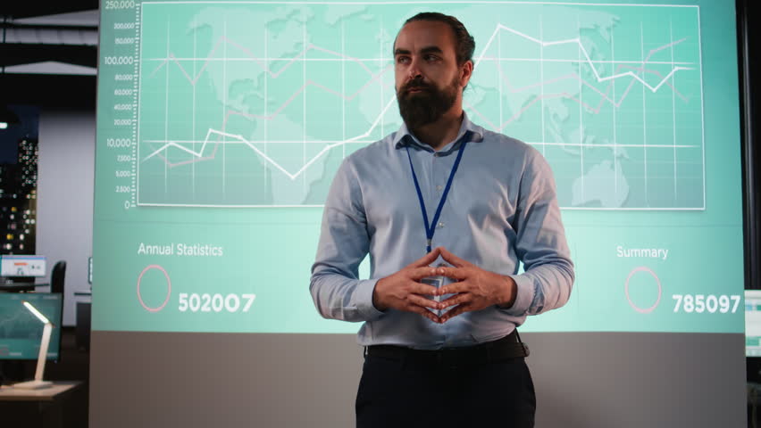 Diverse coworkers attend an after hours business meeting for analysis on files, exchange infographics and performance indicators to ensure project agenda planning. Late night briefing. Camera A.