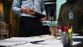 Business colleagues attending in a late night briefing session for teamwork, exchanging documents and reviewing finance updates. Aligning objectives through problem solving. Camera A. - Powered by Shutterstock - Get 15% off with code: PIKWIZARD15