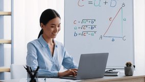 Young Asian woman teacher explaining concepts in a modern office setting - Powered by Shutterstock - Get 15% off with code: PIKWIZARD15