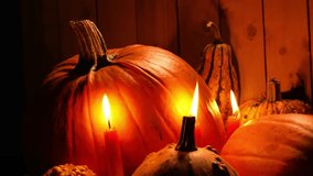 Pumpkin Holiday Background with Candles.Thanksgiving and Halloween Wallpaper. Pumpkins in autumn leaves on wooden background. 4k footage - Powered by Shutterstock - Get 15% off with code: PIKWIZARD15