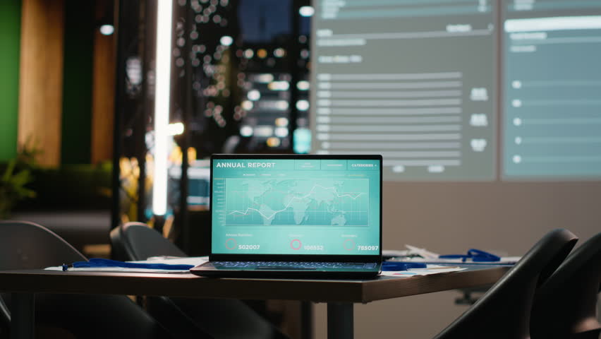Close up of laptop in empty corporate office after hours, projected charts and analytics ready for project briefings and strategic meetings within a success focused organization.