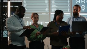 Portrait of multiethnic business team collaborating late at night, assembling in a dark office after hours and working on enterprise development. Diversity within the advisory board group. Camera B. - Powered by Shutterstock - Get 15% off with code: PIKWIZARD15