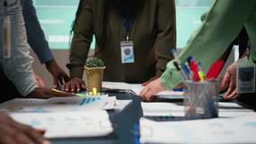 Diverse business team exchanging insights and forecasting diagrams in a late night meeting, reviewing financial data analytics and business intel. Advisory board collaboration. Camera A. - Powered by Shutterstock - Get 15% off with code: PIKWIZARD15