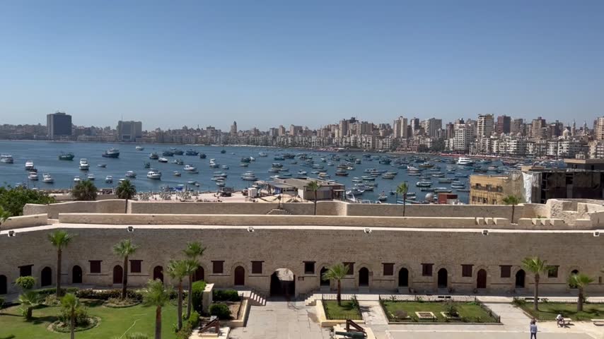 Stunning 4K aerial of Alexandria’s Qaitbay Citadel and sparkling Mediterranean Sea with boats and skyline – ideal for travel ads, tourism promos, and dreamy vacation visuals.