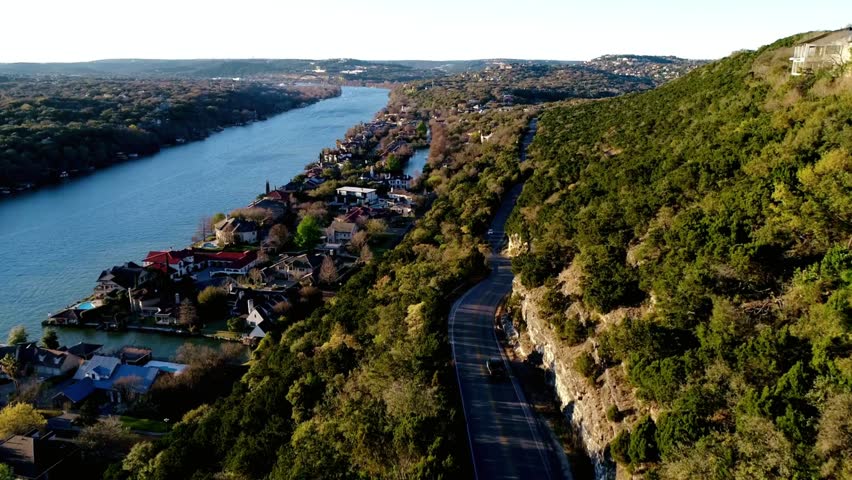Scenic view of lake austin and surrounding hills on a sunny day