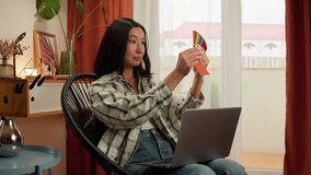 Asian Korean Chinese Japanese woman work laptop holding colors design choosing female lady householder homeowner indoor house renovation samples designer choose color tone interior home order online - Powered by Shutterstock - Get 15% off with code: PIKWIZARD15