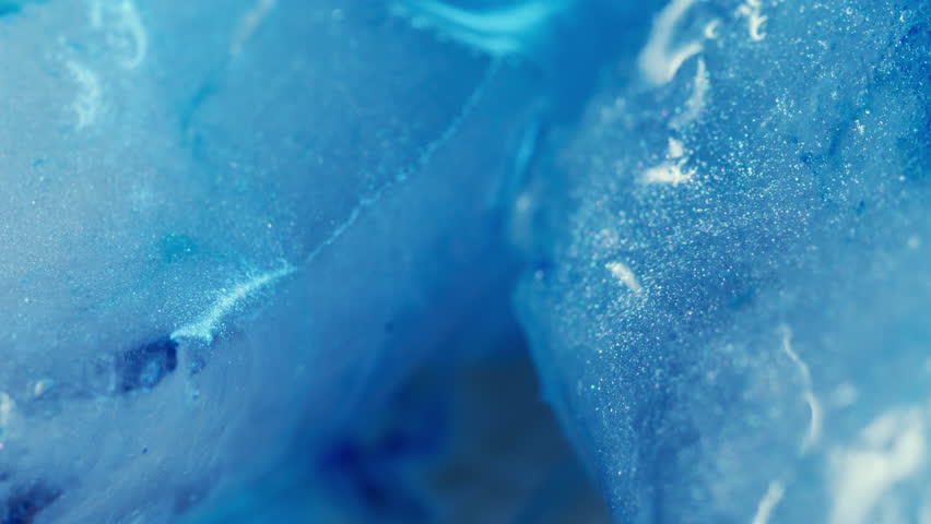 Light fluid. Sparkling ink. Defocused blue color ice water frost texture wet droplets pour on abstract cold creative art background.