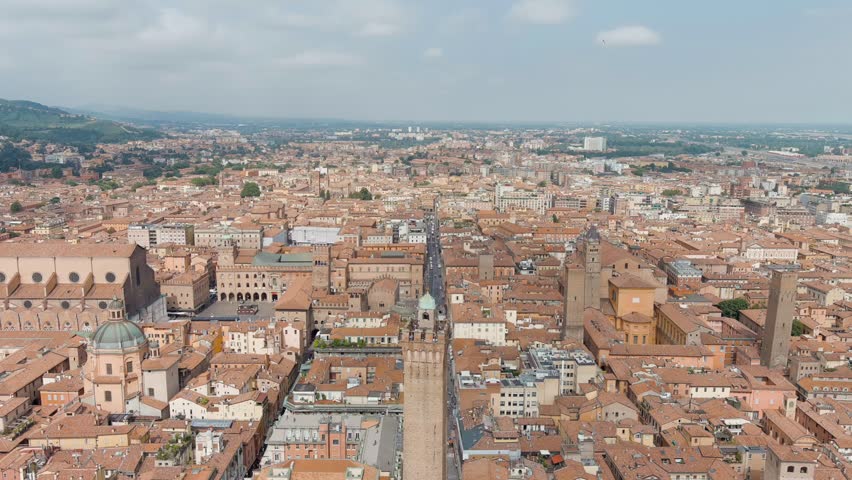 Dolly zoom. Bologna, Italy. Old Town. Two Towers. (Le due Torri) Garisenda and degli Asinelli. Towers from the 12th century. Summer, Aerial View, Departure of the camera