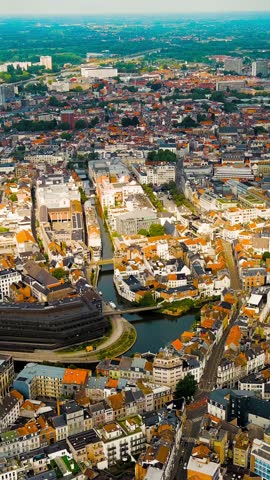Vertical video. Ghent, Belgium. Muinkschelde - Reservoir. Panorama of the central city from the air. Cloudy weather, summer day, Aerial View. Rich colors
