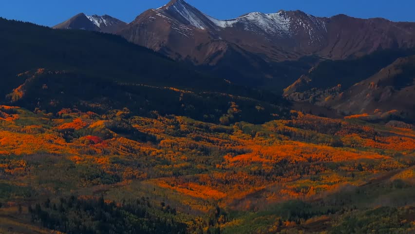 Fall Autumn sunny blue sky morning Aspen Capitol Peak Mount Snowmass aerial drone Colorado vibrant yellow orange White River National Forest snow dusting Rocky mountain peaks parallax circle right pan