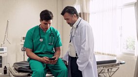Two doctors in a hospital exam room review medical data on a smartphone, representing modern healthcare technology, mobile consultation, and real-time clinical communication and decision-making. - Powered by Shutterstock - Get 15% off with code: PIKWIZARD15