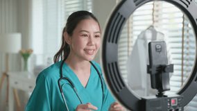 Young adult woman Gen Z asia people anti aging expert modern nurse live talk viral video selfie camera on mobile phone app mental health care. Online sharing digital virtual asian vlogger filming. - Powered by Shutterstock - Get 15% off with code: PIKWIZARD15