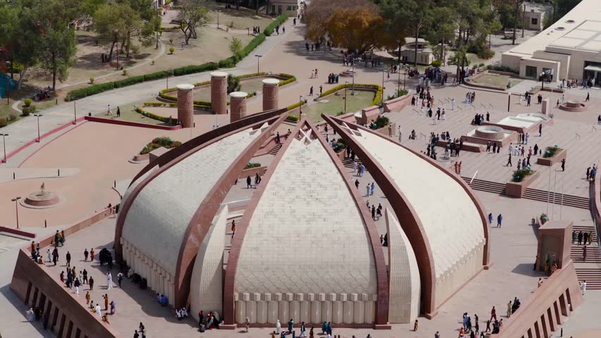 Aerial view of Faisal Mosque in Islamabad, Pakistan, showcasing its iconic architecture and bustling plaza during midday