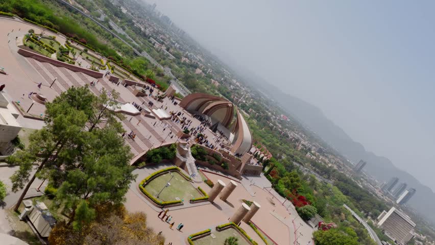 Aerial view of Faisal Mosque in Islamabad, Pakistan, showcasing its unique architecture and bustling surroundings