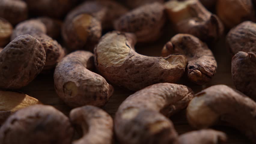 Close-up of raw cashew nuts on wooden surface