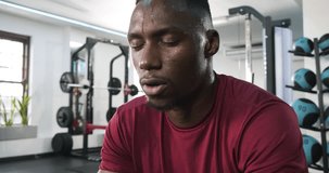 After set, African American man 20s wiping sweat, gathering focus before lifting barbell at gym. Athlete, fitness, determination, strength, resilience, workout, sport - Powered by Shutterstock - Get 15% off with code: PIKWIZARD15