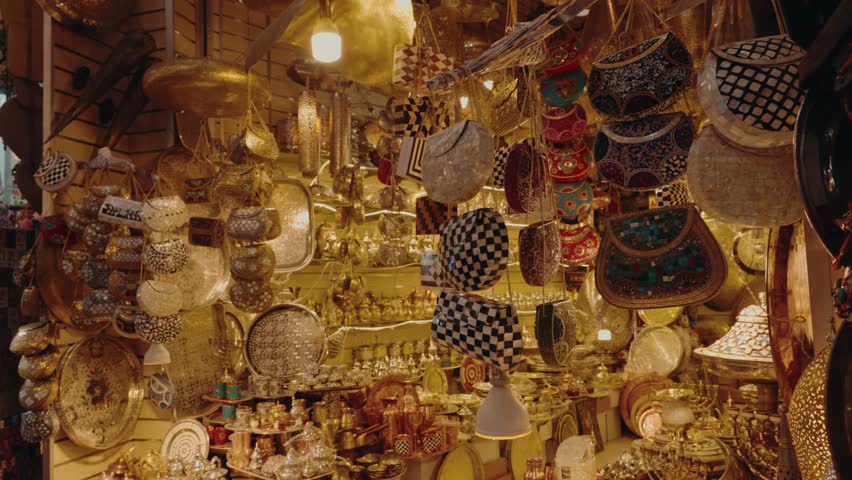 This vibrant stall in a Moroccan souk displays an array of beautiful handcrafted goods. Metal teapots, plates, and purses decorated with colorful stones and patterns. essence of Moroccan craftsmanship