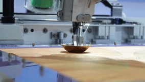 Sewing automate robot. Close up of industrial embroidery or sewing machine precisely stitching patterns onto fabric. Advanced automation in textile production and needlework with high technology. - Powered by Shutterstock - Get 15% off with code: PIKWIZARD15