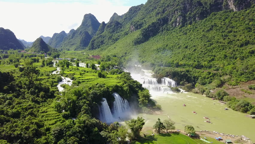 Stunning view of cascading Ban Gioc Waterfalls under bright blue sky