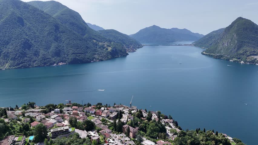 Blue water of Lake Lugano Switzerland high angle drone,aerial 4K footage