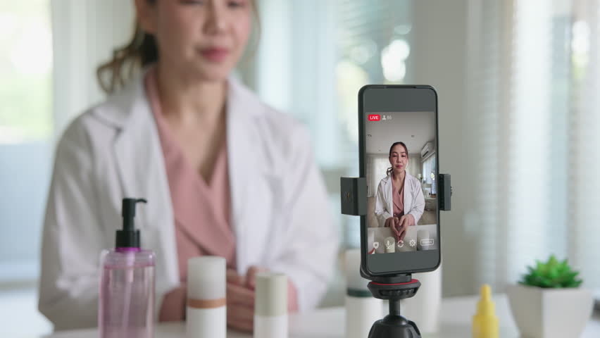 Asia woman people anti aging expert modern health vlogger live advice talk selfie video mobile phone camera. Online digital seller asian small SME store shop owner side hustle filming sell skin care.