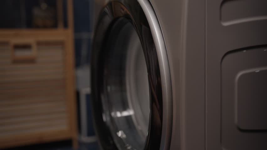 Steam rising from empty washing machine drum after thorough cleaning with steam cleaner, promoting hygiene and effectively eliminating unpleasant odors for fresh laundry experience, close-up, nobody.