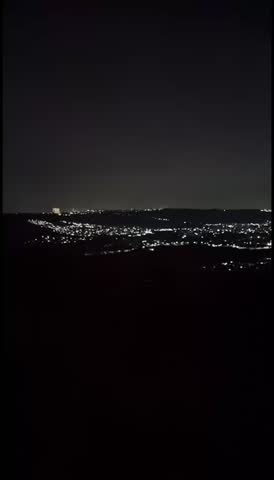 night atmosphere on the mountain with a beautiful view of twinkling lights below 