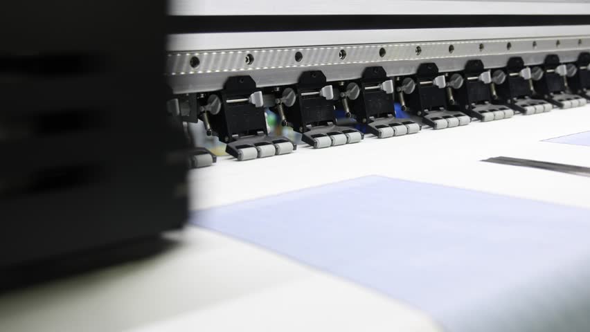High resolution Industry printer. Industrial inkjet printer in operation. printing patterns on large sheet of fabric or paper. Automate printer for modern textile printing and digital print technology
