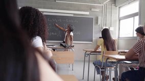 Teacher Explaining Chemistry Formulas to Students in a Classroom Setting at university school. Video with copy space. - Powered by Shutterstock - Get 15% off with code: PIKWIZARD15