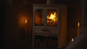 A fireplace with a white mantel and a fire burning in it. The fire is surrounded by candles, and the room is dimly lit. Scene is cozy and warm, with the fire providing a sense of comfort - Powered by Shutterstock - Get 15% off with code: PIKWIZARD15