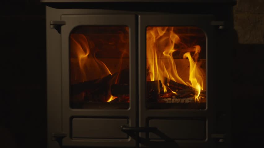 A fireplace with a lot of fire in it. The fire is orange and yellow - Powered by Shutterstock - Get 15% off with code: PIKWIZARD15