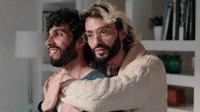 A happy gay couple is embracing and showing their love for each other in their modern apartment. - Powered by Shutterstock - Get 15% off with code: PIKWIZARD15