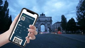 A person holds a smartphone displaying a COVID-19 negative test result in front of an iconic archway. The scene captures a mix of technology and travel safety, emphasizing the importance of health ver - Powered by Shutterstock - Get 15% off with code: PIKWIZARD15